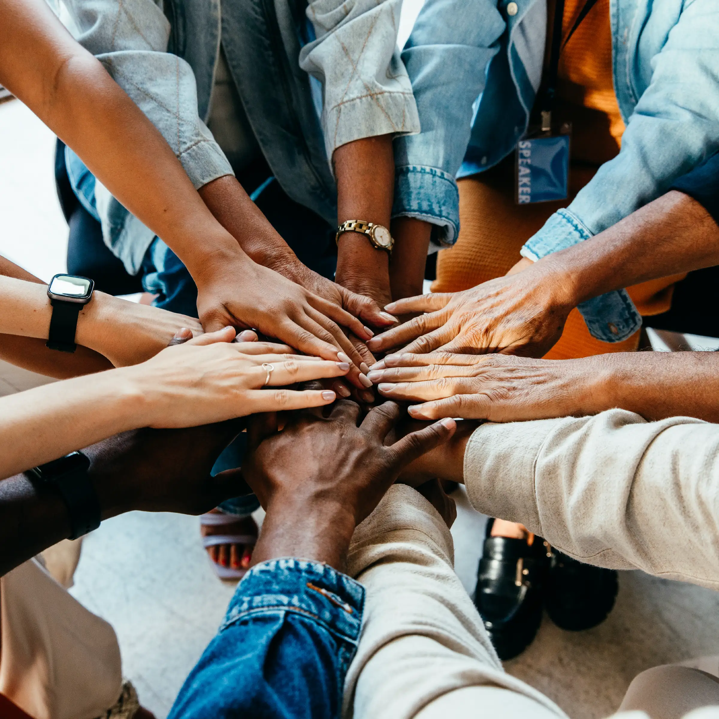 Circle of hands all colours all people