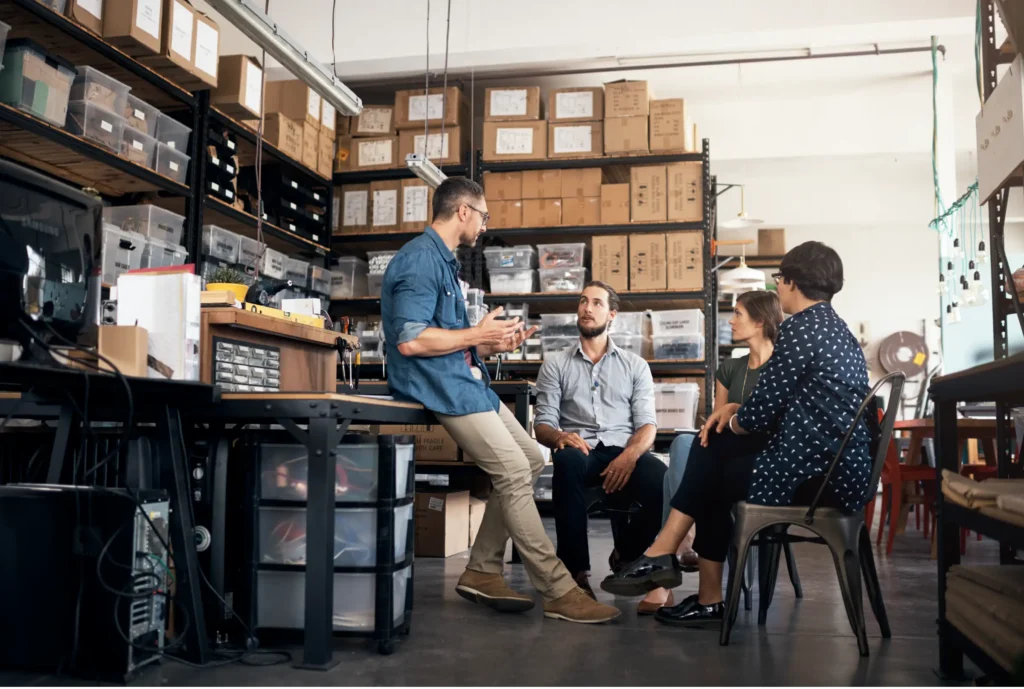 Group of people sitting in room in discussion