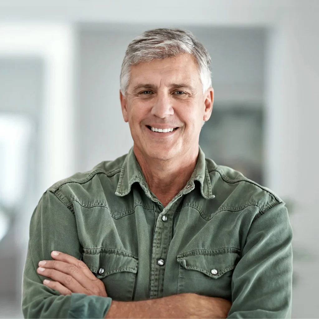 Older Man looking at the camera in green shirt