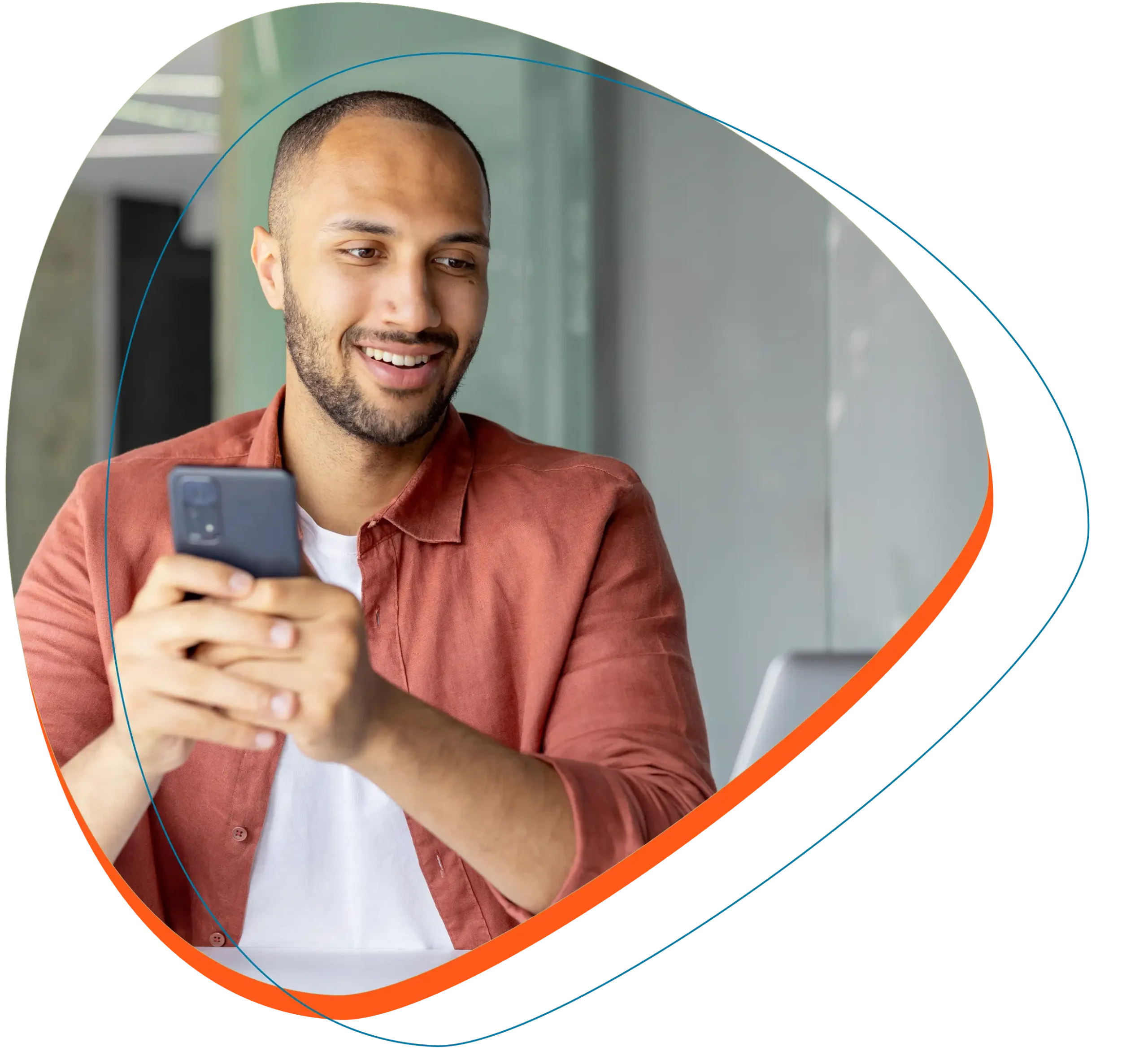 Man with mobile phone looking at laptop