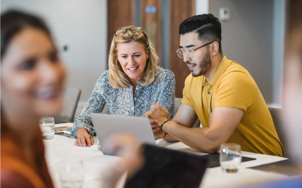 Two academics at desk looking at a computer screen