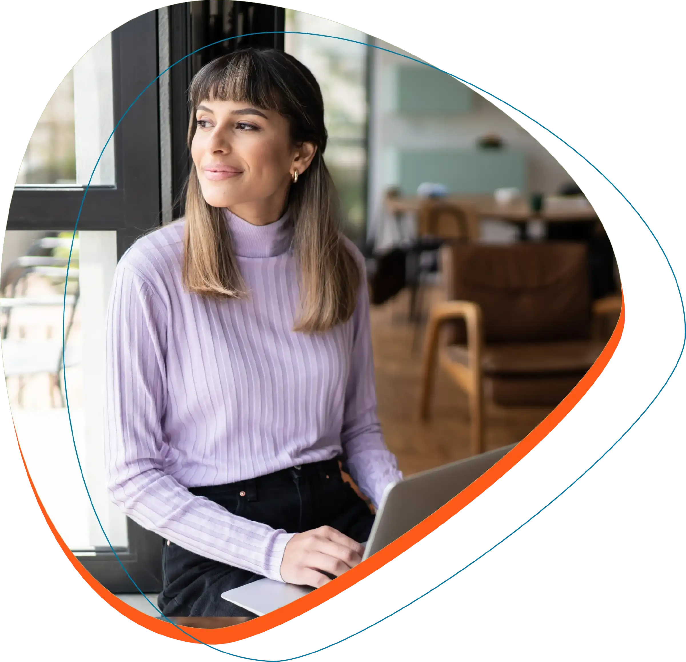 Woman in office with laptop looking into the distance