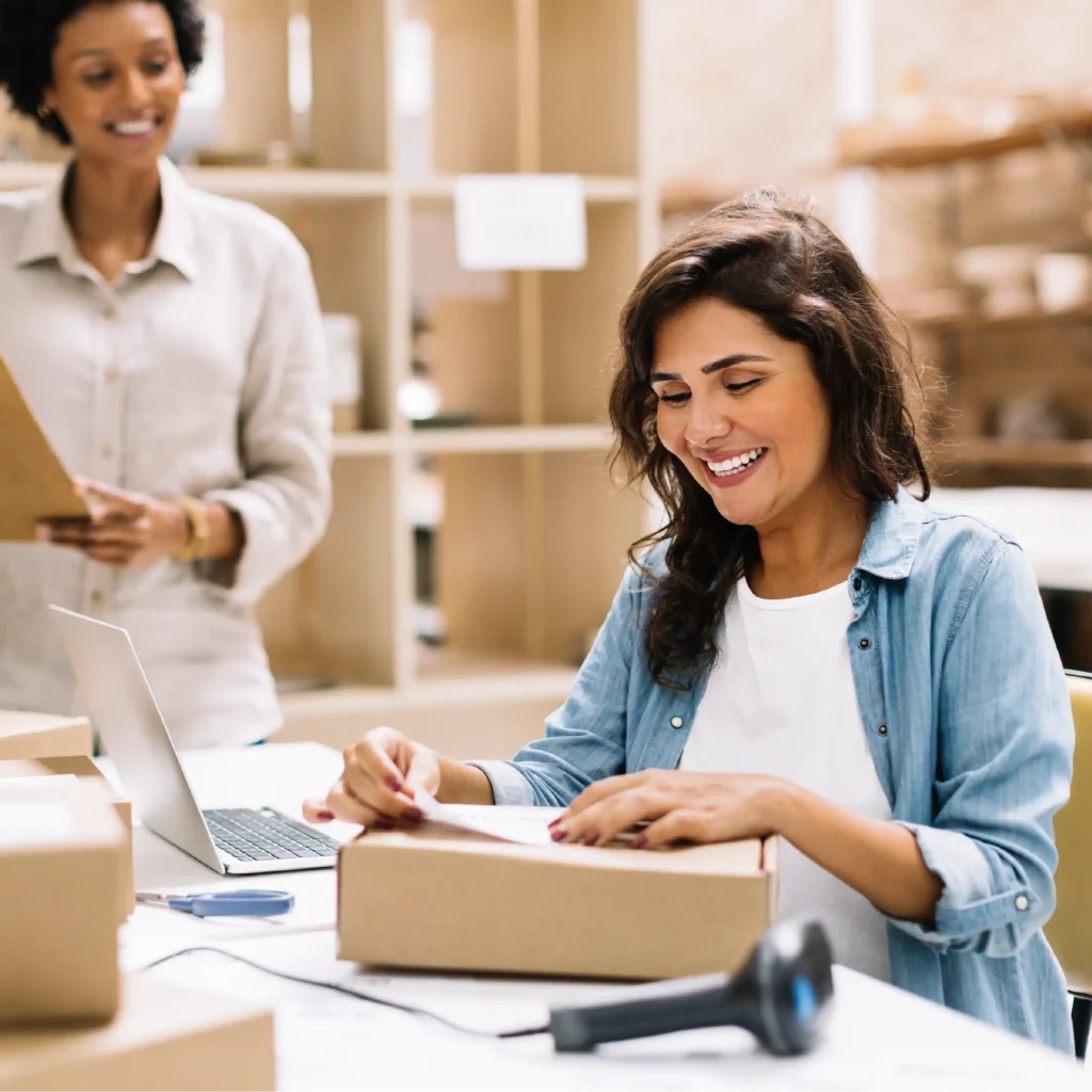 Woman packing boxes for sending from a small business