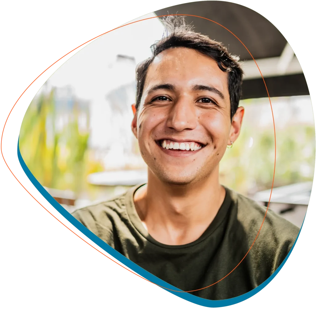 Man looking at the camera in green tee-shirt smiling