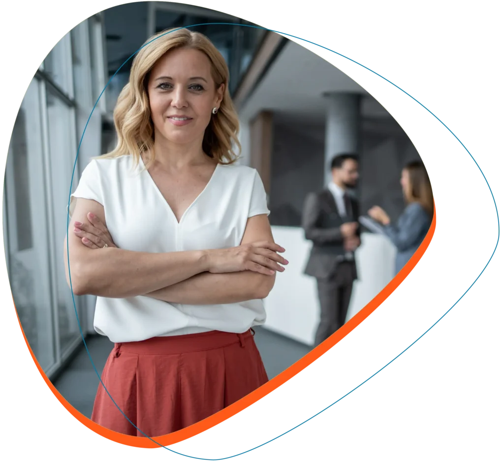 Woman in business attire with arms folded looking at the camera